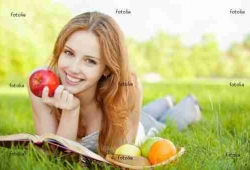 girl lying on the grass and reading a book